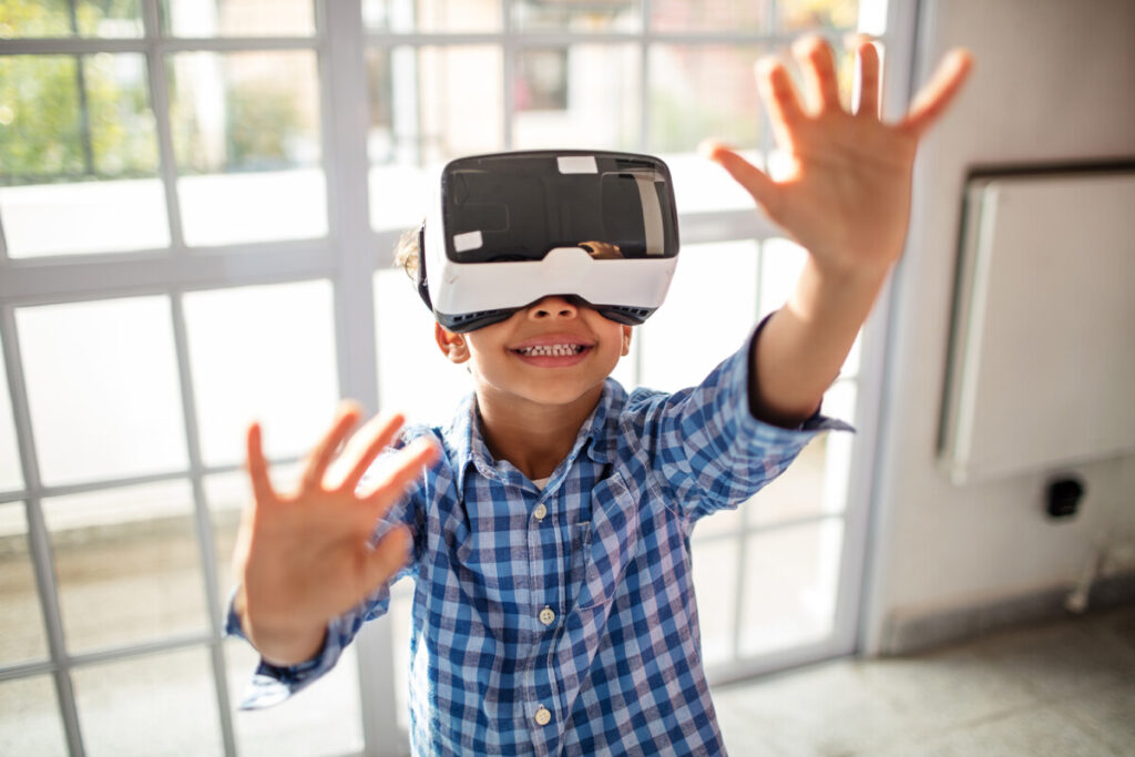 Boy wearing VR headset while gesturing in class