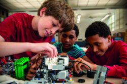 Boys assembling plastic blocks in library